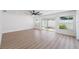 Bright living room with sliding glass doors, and light colored flooring at 7607 22Nd W Ave, Bradenton, FL 34209