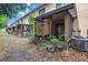 A view of the back of the home showing an enclosed patio, and foliage accenting this outdoor space at 8039 Garden Dr # 105, Seminole, FL 33777