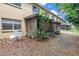 View of a small backyard area, including a screened-in patio and minimal landscaping, showcasing a tranquil outdoor space at 8039 Garden Dr # 105, Seminole, FL 33777