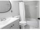 Bathroom features a bathtub and shower combination, along with a vanity and round mirror at 8039 Garden Dr # 105, Seminole, FL 33777