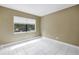 Bedroom featuring tiled flooring, neutral walls and one window with backyard view at 8039 Garden Dr # 105, Seminole, FL 33777
