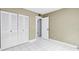 Bedroom featuring tiled floors, neutral walls, and closet with double doors at 8039 Garden Dr # 105, Seminole, FL 33777