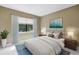 Inviting bedroom features neutral decor, large window with lush outdoor views and plush bedding at 8039 Garden Dr # 105, Seminole, FL 33777