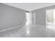 Spacious bedroom with tiled floors and neutral paint, with ensuite bathroom and closet at 8039 Garden Dr # 105, Seminole, FL 33777