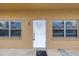 Exterior unit entrance featuring a white front door with windows on either side at 8039 Garden Dr # 105, Seminole, FL 33777