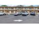 Exterior view of a two-story building with ample parking, featuring a stone accent wall at 8039 Garden Dr # 105, Seminole, FL 33777