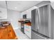 Kitchen with stainless steel appliances, wood countertops, and white cabinets at 8039 Garden Dr # 105, Seminole, FL 33777