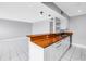 Bright kitchen features white cabinets, stainless steel sink, wooden countertops, and open access to the living area at 8039 Garden Dr # 105, Seminole, FL 33777