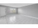 Open living room with white tile flooring and natural lighting at 8039 Garden Dr # 105, Seminole, FL 33777