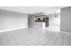 Open living room with white tile flooring, eat-in kitchen, and stainless steel appliances at 8039 Garden Dr # 105, Seminole, FL 33777