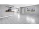 Open living room with white tile flooring, natural lighting, and an eat-in kitchen at 8039 Garden Dr # 105, Seminole, FL 33777
