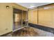 Covered patio featuring wood-look flooring and a sliding glass door, leading to more outdoor space at 8039 Garden Dr # 105, Seminole, FL 33777