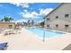 Sparkling community pool showcasing a refreshing oasis, alongside seating areas and lush landscaping at 8039 Garden Dr # 105, Seminole, FL 33777