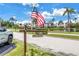 Landmark including an American flag and street sign, near the community, enhancing neighborhood visibility at 8039 Garden Dr # 105, Seminole, FL 33777