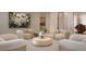 Comfortable lounge area featuring armchairs around a round coffee table, enhanced by elegant decor and lighting at 805 S Gulfview Blvd # 305B, Clearwater, FL 33767