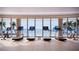 Modern gym with treadmills facing scenic water views through large windows, creating an inspiring workout space at 805 S Gulfview Blvd # 402B, Clearwater, FL 33767