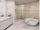 Sleek bathroom featuring a soaking tub and walk-in shower at 805 S Gulfview Blvd # 602A, Clearwater, FL 33767