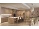 Modern kitchen with a waterfall island, wine fridge, and dining table with seating at 805 S Gulfview Blvd # 602A, Clearwater, FL 33767