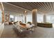 Open lounge area featuring a long wood table, sofas, and floor to ceiling windows at 805 S Gulfview Blvd # 602A, Clearwater, FL 33767