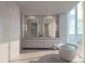 Luxurious bathroom with a freestanding tub, dual vanities, and a large window with a scenic view at 805 S Gulfview Blvd # 701B, Clearwater, FL 33767