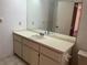 Bathroom featuring single sink vanity, tile flooring, and large mirror at 8130 Shalom Dr, Spring Hill, FL 34606