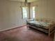 This carpeted bedroom has wood paneling, two windows, and a daybed at 8130 Shalom Dr, Spring Hill, FL 34606