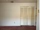 Bedroom featuring a neutral color palette, carpet, and bi-fold closet doors at 8130 Shalom Dr, Spring Hill, FL 34606