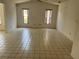 Bright bonus room with vaulted ceilings, tile flooring, and natural light from two windows at 8130 Shalom Dr, Spring Hill, FL 34606