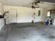 Spacious garage with concrete floor, equipped with ceiling fan and storage solutions, ready for vehicles and projects at 8130 Shalom Dr, Spring Hill, FL 34606
