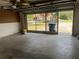 Bright garage featuring a screen door allowing natural light, perfect for working on projects or storing vehicles at 8130 Shalom Dr, Spring Hill, FL 34606