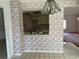 Open-concept kitchen with outdated wallpaper, tile flooring, and view of the dining room at 8130 Shalom Dr, Spring Hill, FL 34606