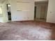 Open-concept living room leading to kitchen and other areas, with tile and carpet flooring at 8130 Shalom Dr, Spring Hill, FL 34606