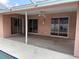 Covered patio features stucco walls, ceiling fan and multiple sliding glass doors at 8130 Shalom Dr, Spring Hill, FL 34606