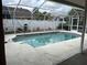 In ground swimming pool featuring a screened enclosure and tile accents at 8130 Shalom Dr, Spring Hill, FL 34606