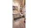 Inviting bathroom featuring wood-look tile, spacious vanity, and charming decor at 834 Tremont Greens Ln # 137, Sun City Center, FL 33573