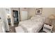 Bright bedroom with a comfortable bed, coastal decor, and a door to a private bathroom at 834 Tremont Greens Ln # 137, Sun City Center, FL 33573