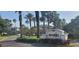 Kings Point South Club entrance with beautiful landscaping and palm trees at 834 Tremont Greens Ln # 137, Sun City Center, FL 33573