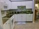Bright kitchen featuring white cabinetry, granite countertops, and stainless steel appliances at 834 Tremont Greens Ln # 137, Sun City Center, FL 33573