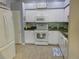 Efficient kitchen featuring white cabinetry, modern appliances, and durable countertops; a functional design at 834 Tremont Greens Ln # 137, Sun City Center, FL 33573