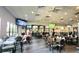 Casual restaurant with tables and chairs for dining, multiple TVs, and a bar area at 834 Tremont Greens Ln # 137, Sun City Center, FL 33573