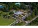 Expansive aerial view showcases a well-maintained community center with ample parking and surrounding recreational spaces at 8701 Lake Calm Ln, Odessa, FL 33556
