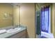 Bathroom features a vanity with a large mirror, a shower-tub combo, and plenty of storage at 8701 Lake Calm Ln, Odessa, FL 33556