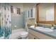 Well-lit bathroom with a shower-tub combo, neutral tile, and a vanity with plenty of storage space at 8701 Lake Calm Ln, Odessa, FL 33556