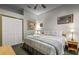 Cozy bedroom features a queen-sized bed, ceiling fan, and bedside tables with lamps at 8701 Lake Calm Ln, Odessa, FL 33556