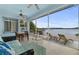 Screened lanai offers water views, ceiling fans, and lounge seating for relaxing and entertaining at 8701 Lake Calm Ln, Odessa, FL 33556