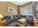Inviting living room featuring a comfortable sectional sofa and decorative ottoman, perfect for relaxation at 8701 Lake Calm Ln, Odessa, FL 33556