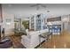 Open-concept living room featuring hardwood floors, neutral tones, and access to kitchen at 8701 Lake Calm Ln, Odessa, FL 33556