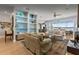 Open living room featuring hardwood floors, views of the lake, and designer built-ins at 8701 Lake Calm Ln, Odessa, FL 33556