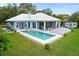 Aerial view of backyard with private in ground pool, large deck and screened in porch at 8701 Lake Calm Ln, Odessa, FL 33556