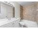 Bathroom featuring a tiled shower, bath and a large mirror at 9130 Tudor Dr # M105, Tampa, FL 33615